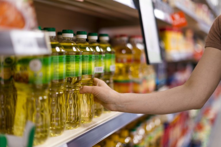 Woman,Buying,Cooking,Oil,In,Supermarket,,Close-up