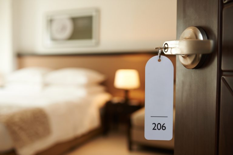 Opened,Door,Of,Hotel,Room,With,Key,In,The,Lock