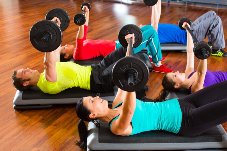 Group,Of,Young,Sport,People,Training,With,Barbell,At,A