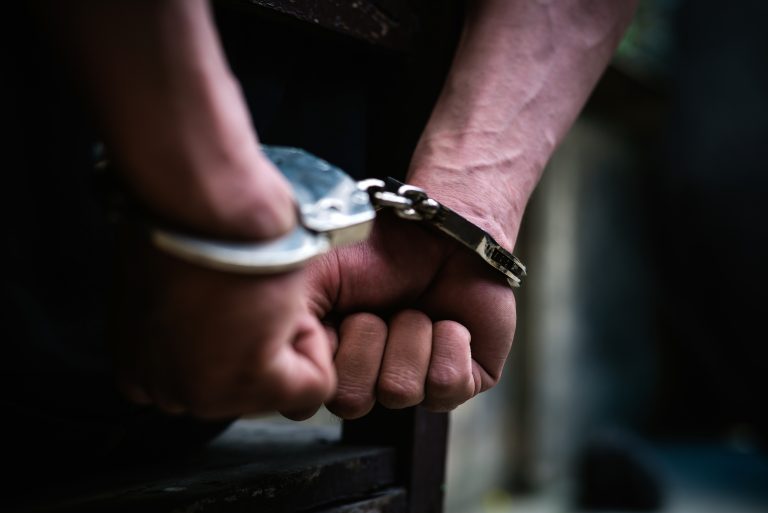 Man,On,The,Chair,In,Handcuffs.,Rear,View,And,Closeup