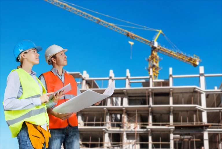 Foreman,And,Engineer,With,Blueprints,At,Construction,Site