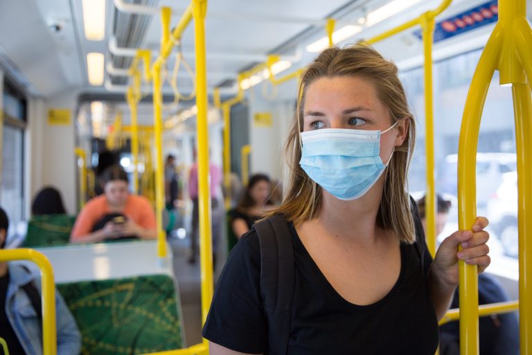 Young,Woman,Wearing,A,Face,Mask,Riding,Public,Transport