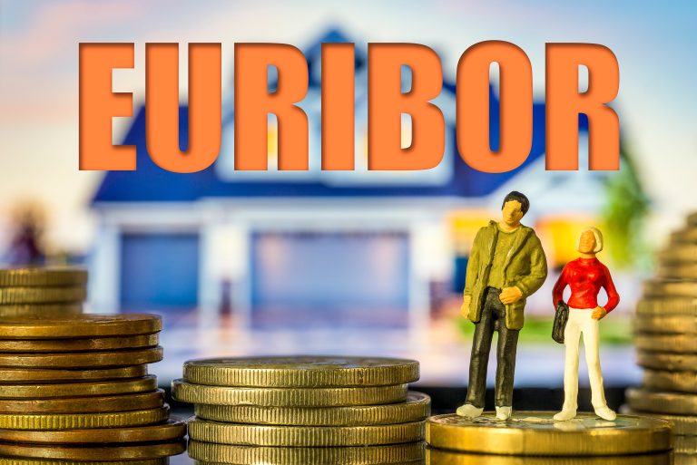 Miniature,People,Young,Couple,Standing,On,Coin,Stack,In,Front