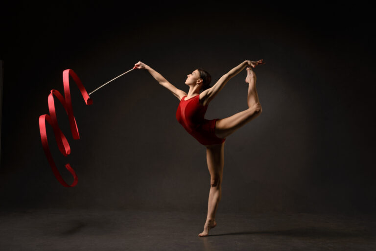 Rhythmic,Gymnast,In,Red,Leotard,With,Ribbon