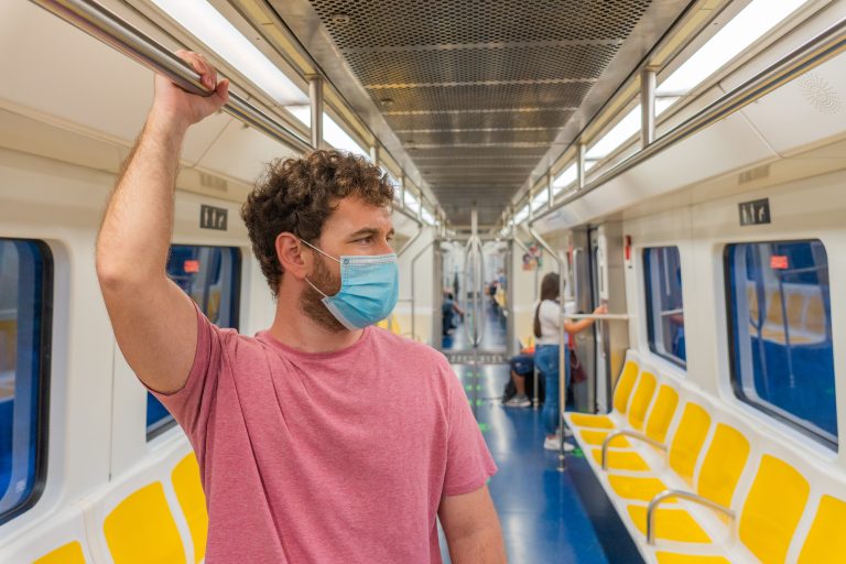 Public,Transport,,Portrait,Young,Man,Traveling,Inside,Train,Standing,While