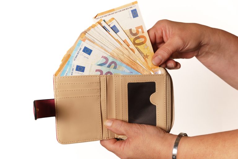 Woman,Taking,Euro,Banknotes,Out,Of,Her,Wallet