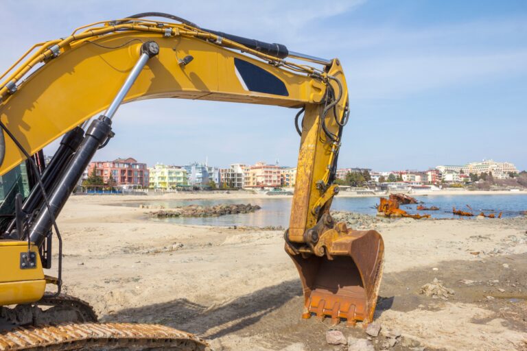 The,Yellow,Excavator,Bucket,Stands,On,The,Sand,On,The