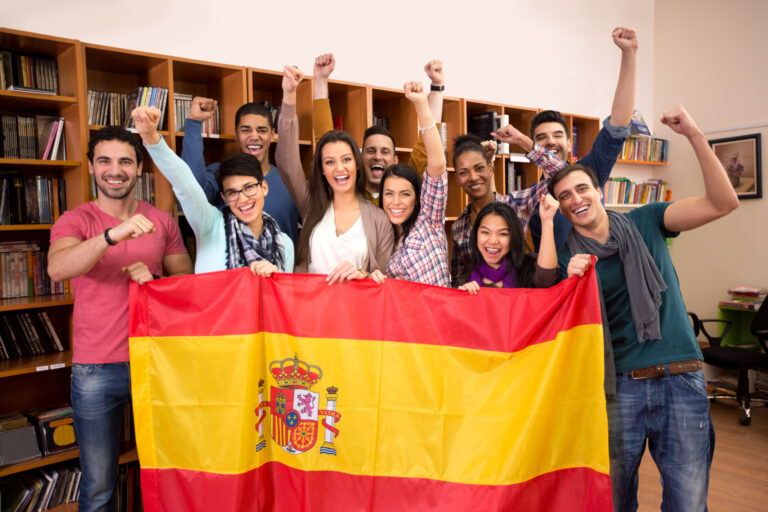Team,Of,Excited,Spanish,Students,With,Victory,Smile,And,Raised