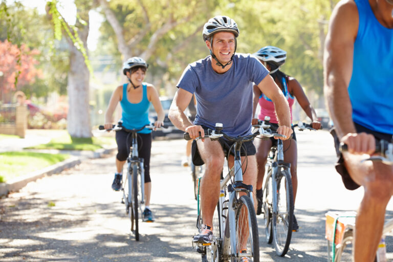 Group,Of,Cyclists,On,Suburban,Street