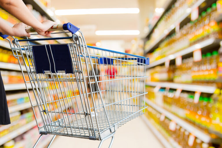 Woman,Pushing,Shopping,Cart,In,Supermarket