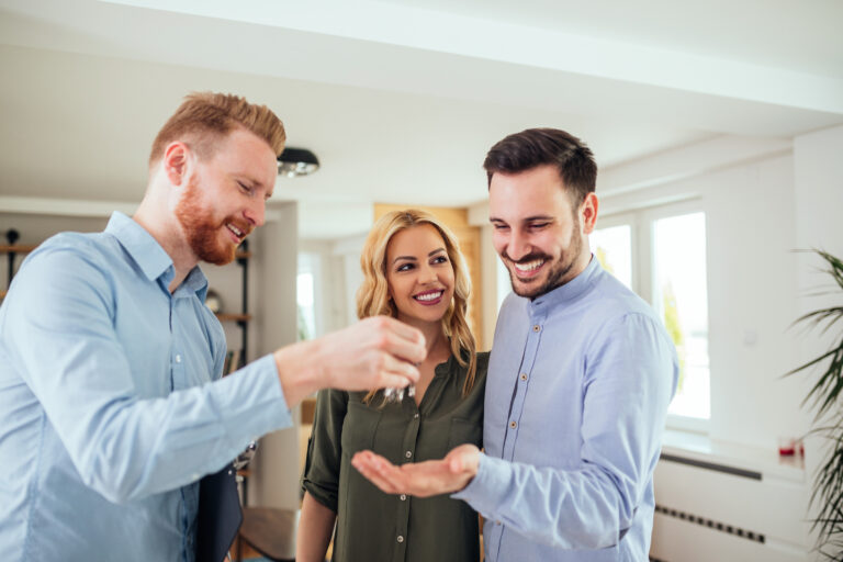 Real,Estate,Agent,Handing,Over,The,Key,To,The,Happy