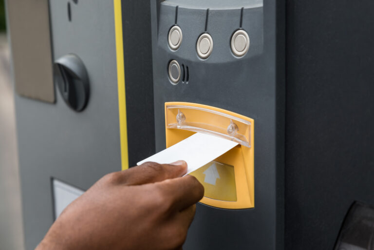 Close-up,Of,Person's,Hand,Inserting,Ticket,Into,Parking,Machine,To