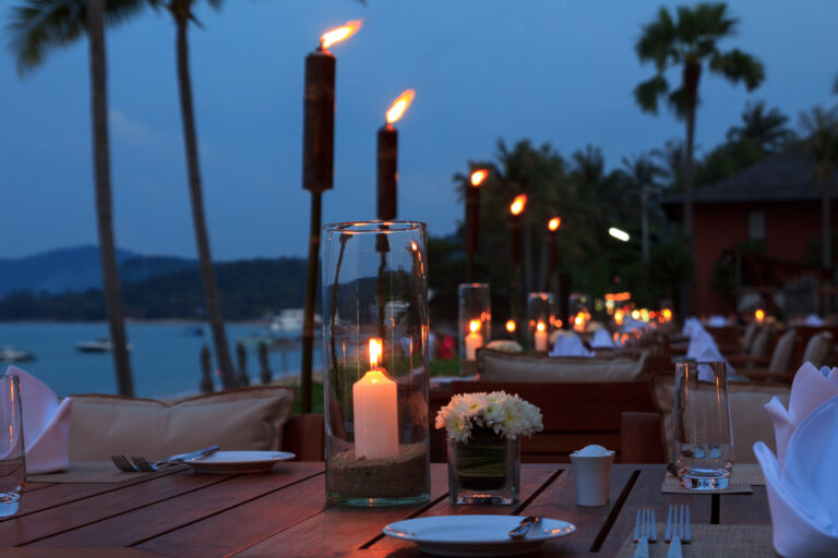 Outdoor,Restaurant,Tables,,Dinner,Setting,On,The,Beach,At,Evening