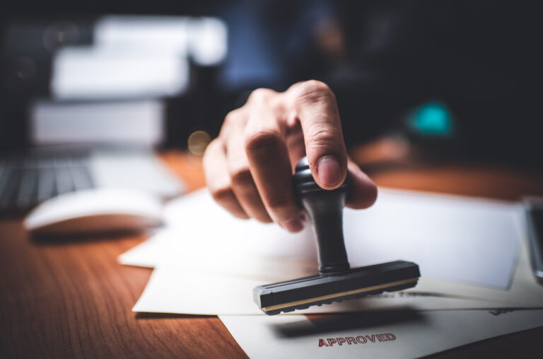 Close-up,Of,A,Person's,Hand,Stamping,With,Approved,Stamp,On