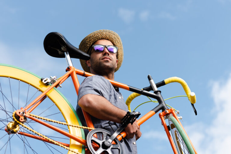 Hispanic,Hipster,Carrying,A,Colorful,Fixie,Bicycle,On,His,Shoulder