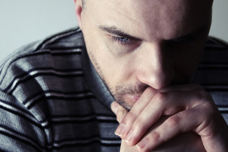 Young,Man,Sitting,Looking,Upset