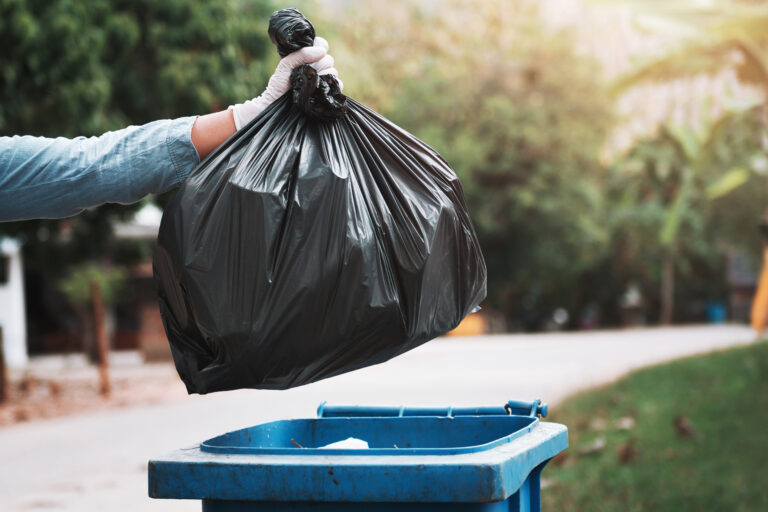 Hand,Holding,Garbage,Black,Bag,Putting,In,To,Trash