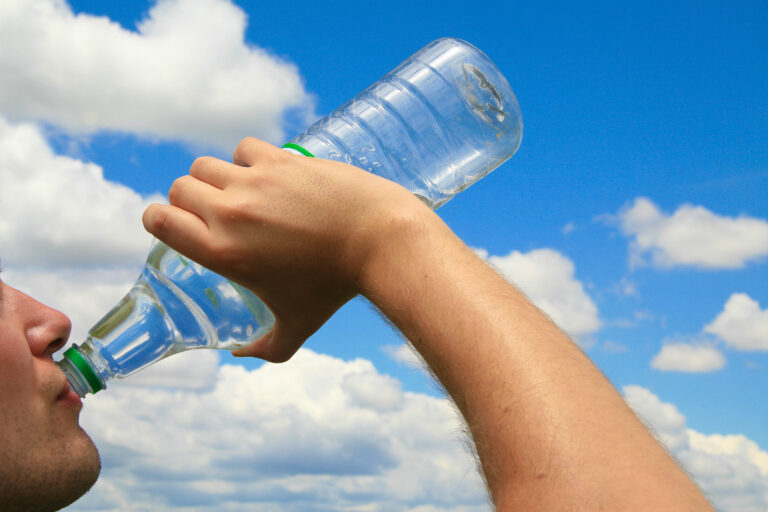 Man,Drinking,Water,Out,Of,Polyethylene,Plastic,Bottle,In,Front