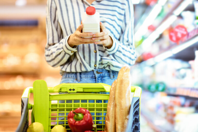 Grocery,Shopping.,Closeup,Of,Unrecognizable,Female,Customer,Holding,Bottle,Of