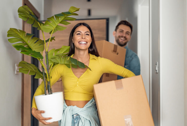 Young,Couple,Moving,In,New,Home.couple,Is,Having,Fun,With