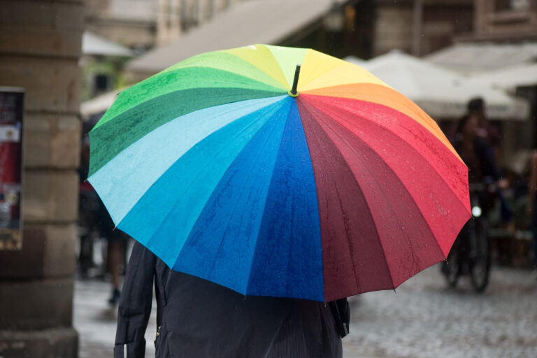 Portrait,On,Back,View,Of,Man,Walking,With,A,Rainbow