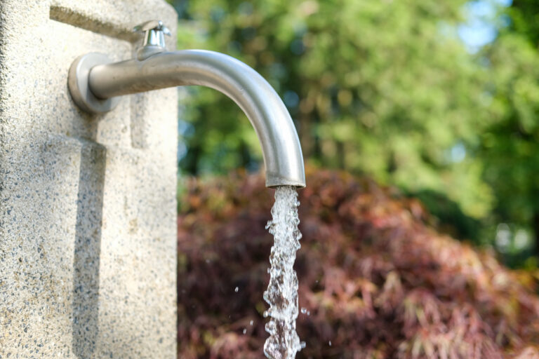 Close-up:,Cold,Clear,Water,Spouting,From,A,Metal,Faucet,From