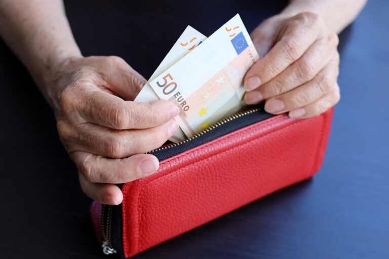 Euro,Banknotes,In,Red,Wallet,In,Wrinkled,Hands,Of,Elderly