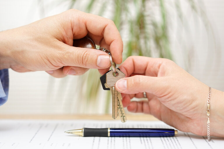Real,Estate,Agent,Gives,House,Keys,To,His,Client,After