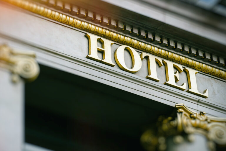 Sun,Flare,Above,Hotel,Word,With,Golden,Letters,On,Luxury