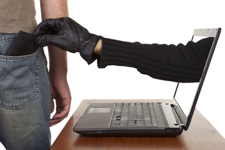 Internet,Theft,-,A,Gloved,Hand,Reaching,Through,A,Laptop