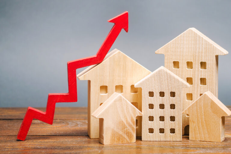 Miniature,Wooden,Houses,And,Red,Arrow,Up.,The,Concept,Of