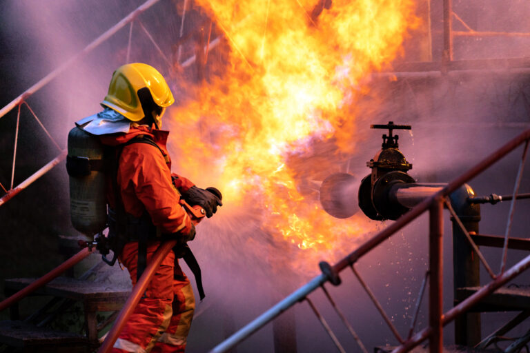 Firefighter,Using,Water,Fog,Type,Fire,Extinguisher,To,Fighting,With