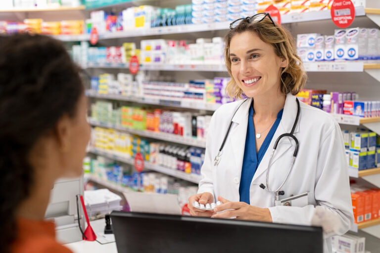 Pharmacist,Giving,Medicine,To,Customer,In,Modern,Pharmacy.,Rear,View