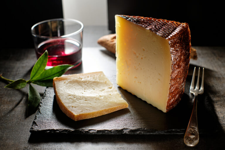 Tasty,Cured,Manchego,Cheese,With,Glass,Of,Wine