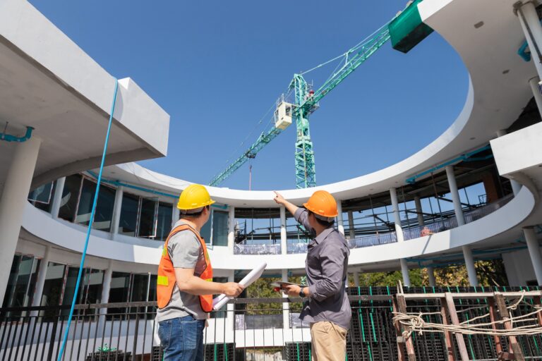 Two,Young,Structural,Engineer,And,Architect,Dressed,In,Orange,Work