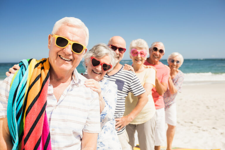 Portrait,Of,Smiling,Senior,Friends,On,The,Beach
