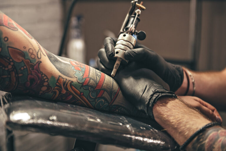 Close,Up,Tattoo,Machine.,Man,Creating,Picture,On,Hand,With