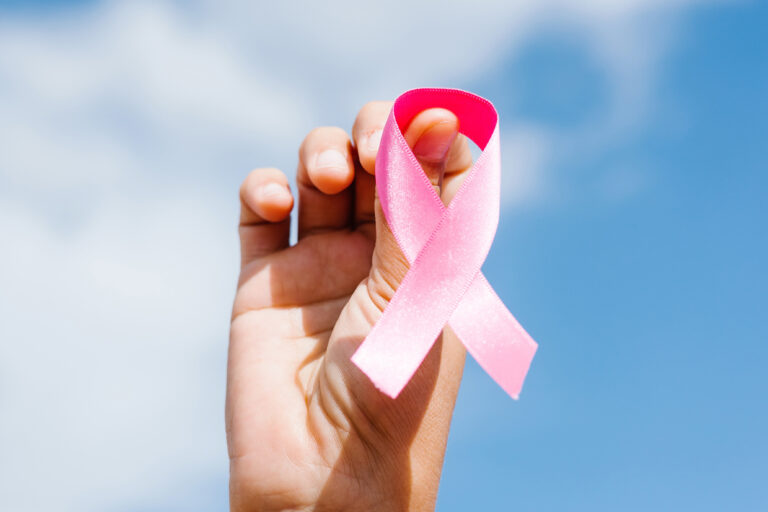 Woman,Hands,Holding,Pink,Breast,Cancer,Awareness,Ribbons,With,Blue