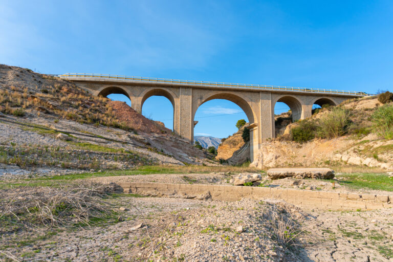 Small,Brick,And,Masonry,Bridge,Over,A,Dry,Riverbed,Surrounded