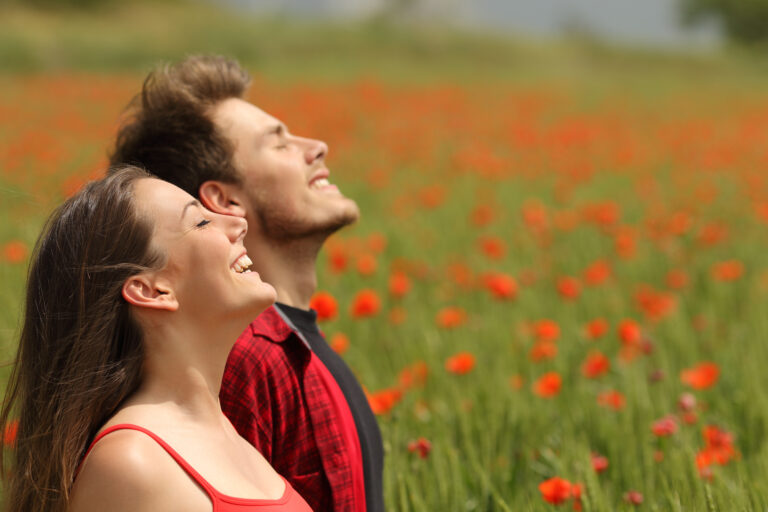 Happy,Couple,Breathing,Fresh,Air,In,A,Colorful,Field,With
