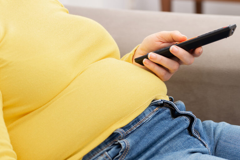 Side,View,Of,Young,Obese,Woman,Relaxing,On,Sofa,And