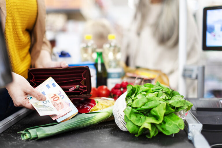 Close-up,Of,Woman,Giving,Money,At,The,Cash,Desk,In