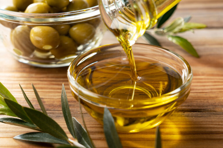 The,Moment,Olive,Oil,Is,Poured,Into,A,Glass,Bowl