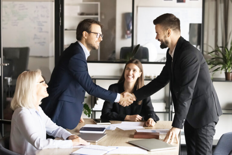 Two,Happy,Confident,Business,Partners,Men,Shaking,Hands,Over,Large