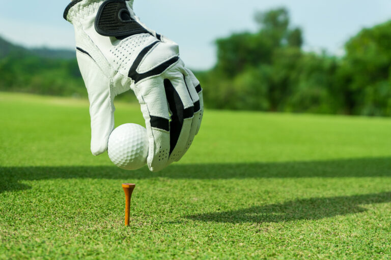 Hand,Hold,Golf,Ball,With,Tee,On,Course,,Tee,Off,