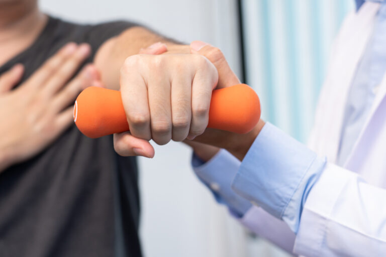 Physiotherapist,Doctor,Rehabilitation,Consulting,Physiotherapy,Giving,Dumbbell,Exercising,Treatment,With