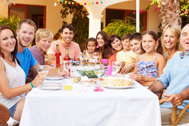 Large,Family,Group,Enjoying,Meal,On,Terrace,Together