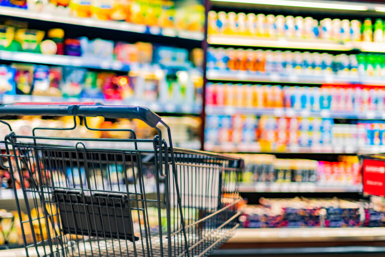 A,Shopping,Cart,By,A,Store,Shelf,In,A,Supermarket