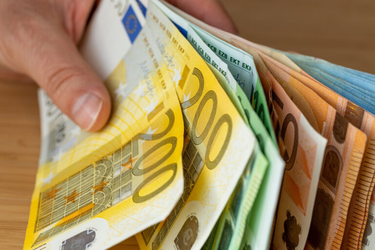 Bundles,Of,Euro,Money,,Bundle,Of,Banknotes,Held,In,A