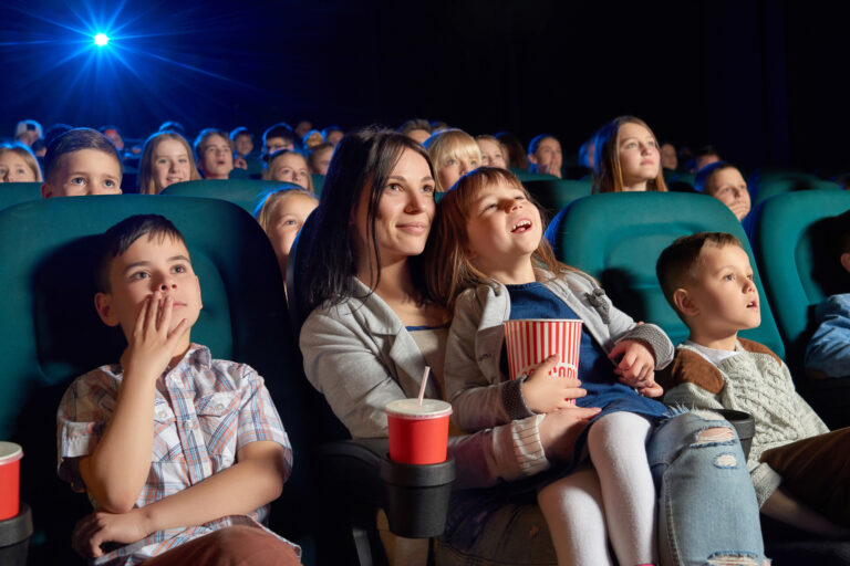 Low,Angle,Shot,Of,People,Watching,A,Movie,At,The